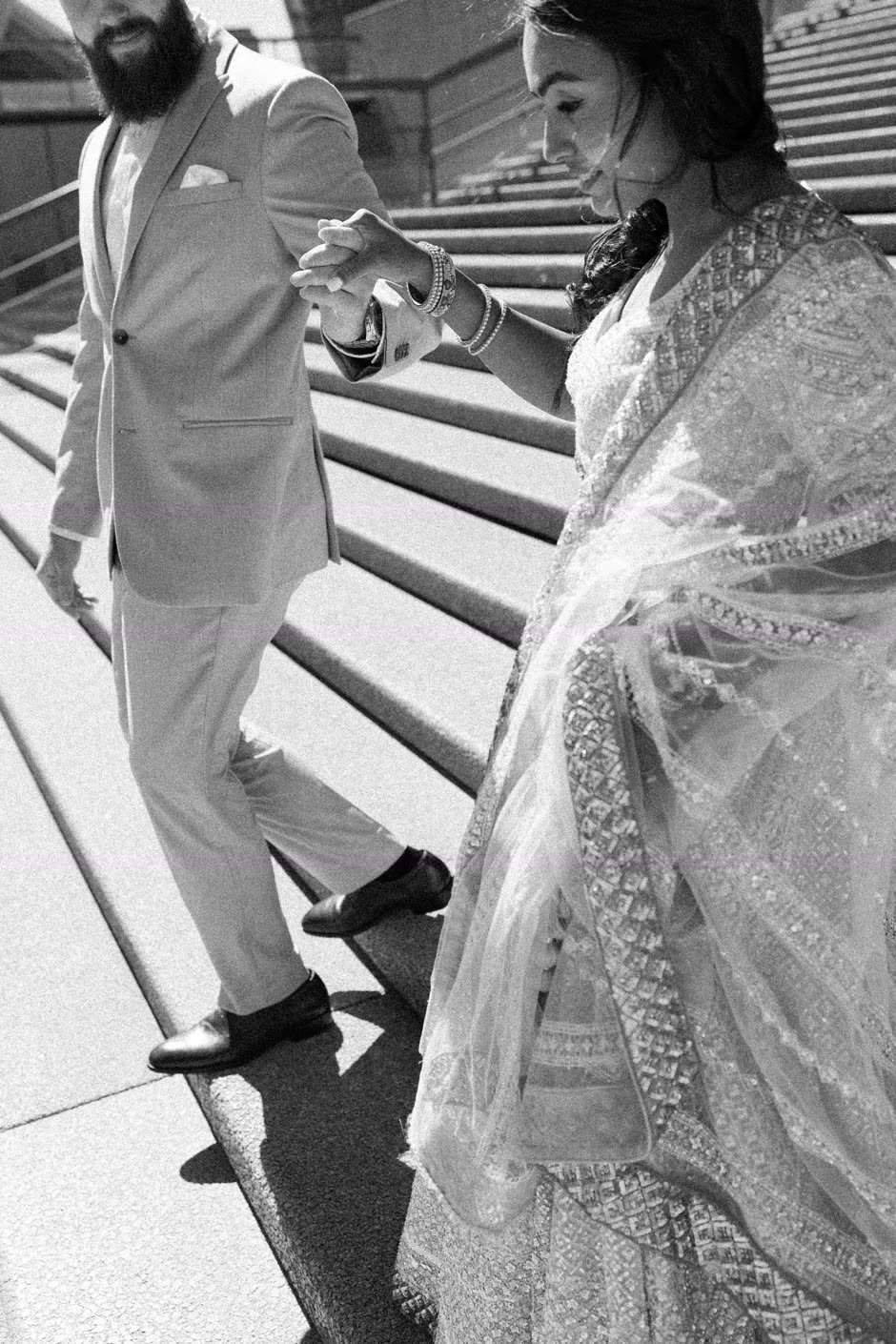 A couple on the steps of the Sydney Opera House, in black and white