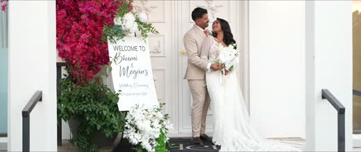 The couple at the welcome sign outside the ceremony